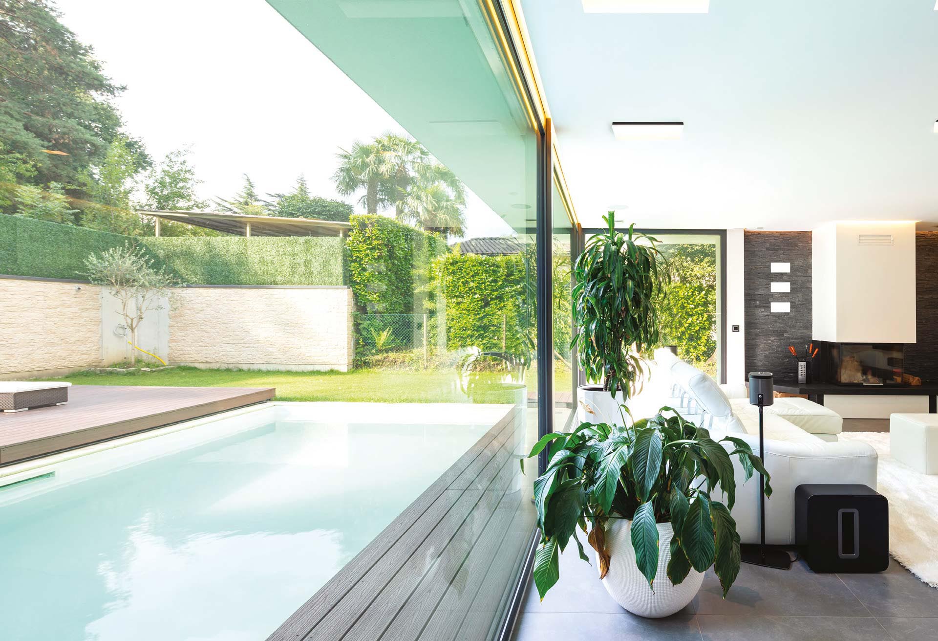 Modern living room overlooking the garden and swimming pool.